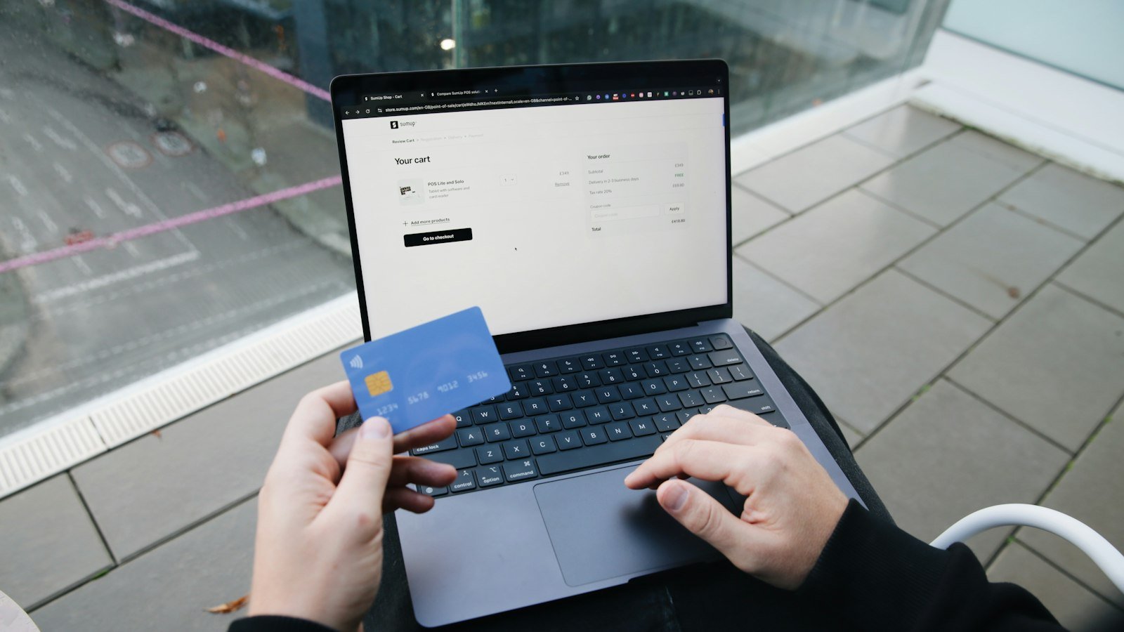 A laptop and payment card used for an online purchase